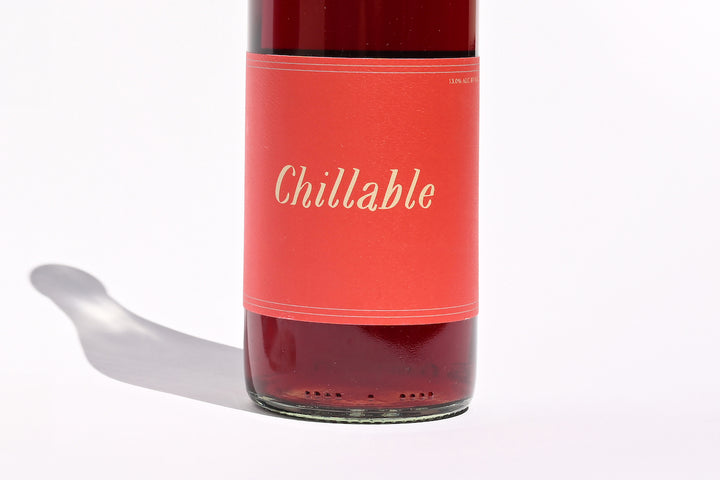 Close-up of Swick Wines 2022 Chillable Red bottle label showing the coral-pink label design with Chillable written in white script