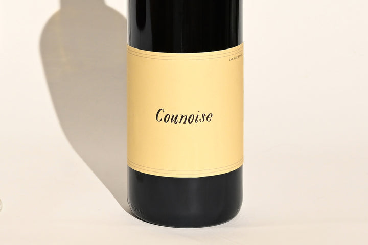 Close-up of Swick Wines 2022 Counoise bottle label with cursive text on cream background and black lower section