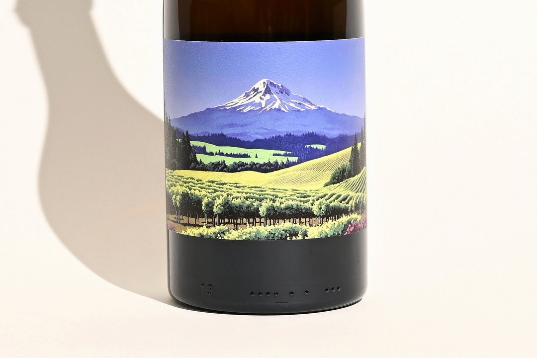 Close-up of Swick Wines 2022 Gewurztraminer bottle label featuring scenic Mt. Hood mountain landscape with green vineyard fields