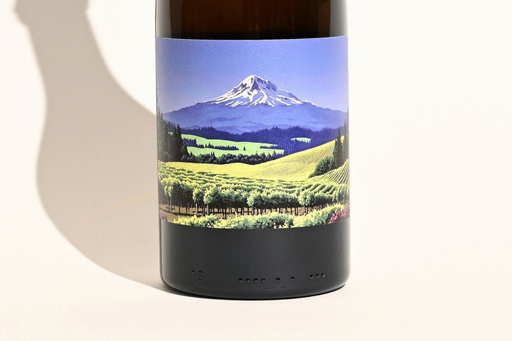 Close-up of Swick Wines 2022 Gewurztraminer bottle label featuring scenic Mt. Hood mountain landscape with green vineyard fields