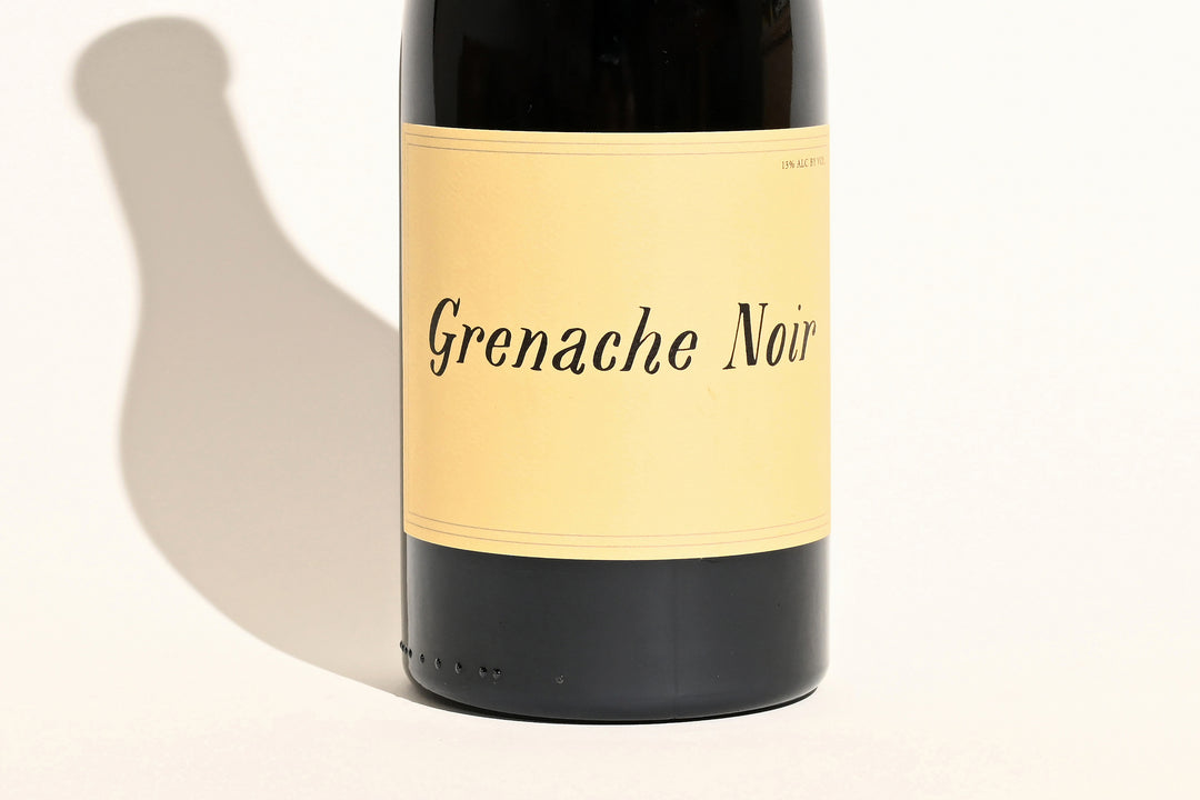 Close-up of Swick Wines 2022 Grenache Noir bottle label showing handwritten-style typography