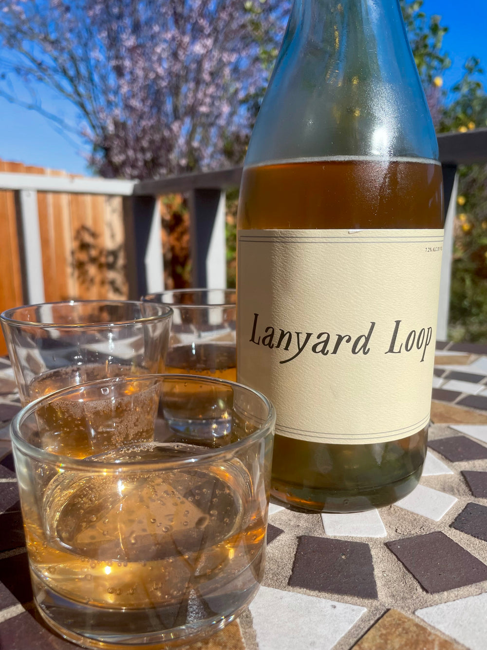 Lanyard Loop - Orange wine bottle patio with glasses
