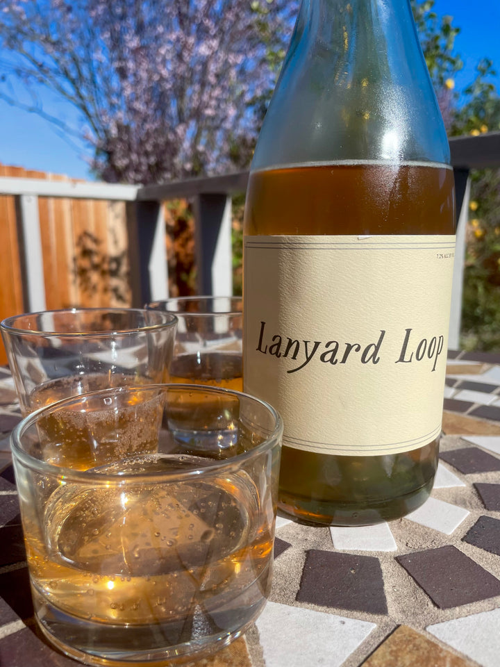 Lanyard Loop - Orange wine bottle patio with glasses