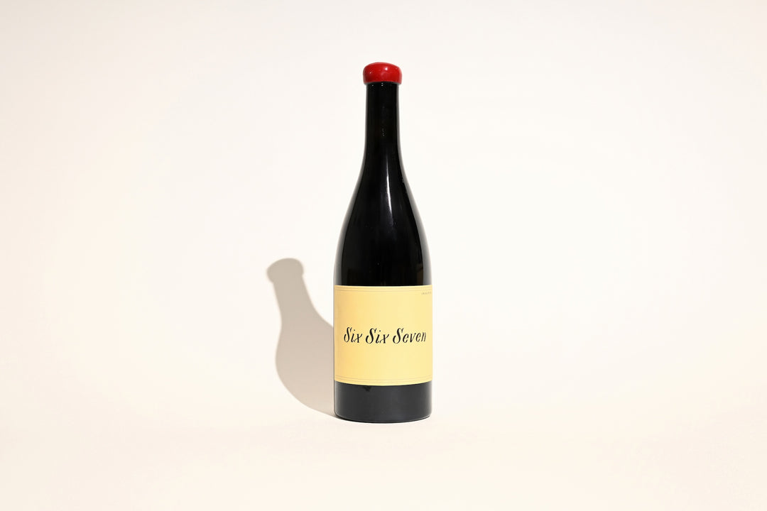 Swick Wines 2023 Six Six Seven red blend bottle with red wax cap and cream label on beige background