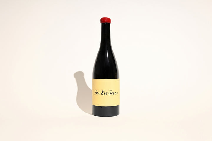 Swick Wines 2023 Six Six Seven red blend bottle with red wax cap and cream label on beige background