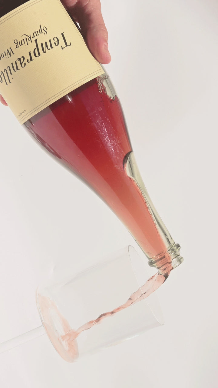 Video of Swick Wines 2021 Tempranillo Sparkling Wine being poured showing effervescent bubbles and deep pink red color